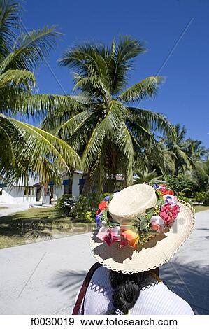 Stock Photo - French Polynesia, Tuamotus, Fakarava, going to sunday mass, decorated hat. Fotosearch