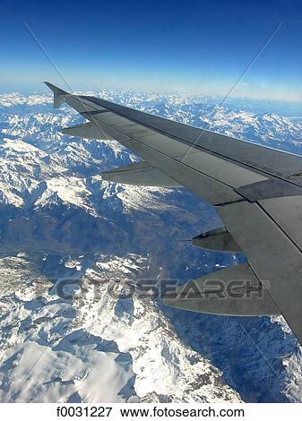Stock Photo - Italy, Alps, above snowy mountains, aerial view. Fotosearch