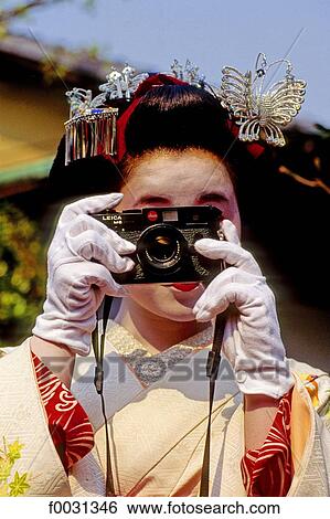 Japan, Kyoto, maiko shooting a photograph View Large Photo Image Stock Photograph - Japan, Kyoto, maiko shooting a photograph. Fotosearch