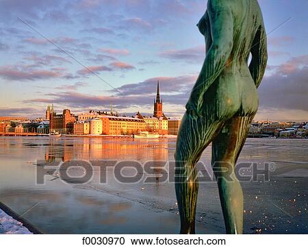 Sweden, Stockholm, Gamla Stan: old city, Riddarholmen island view from the city hall in winter, statue at fore View Large Photo Image Stock Image - Sweden, Stockholm, Gamla Stan: old city, Riddarholmen island view from the city hall in winter, statue at fore. Fotosearch
