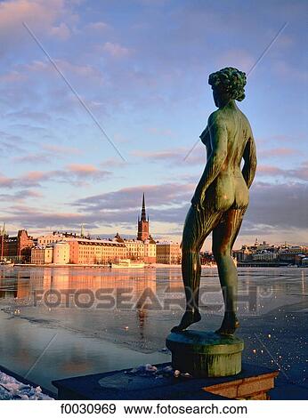 Sweden, Stockholm, Gamla Stan: old city, Riddarholmen island view from the city hall in winter, statue at fore View Large Photo Image Stock Photo - Sweden, Stockholm, Gamla Stan: old city, Riddarholmen island view from the city hall in winter, statue at fore. Fotosearch