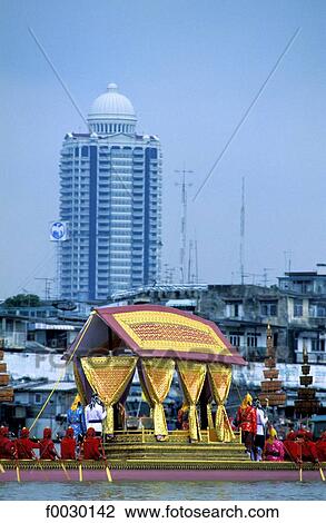Thailand, Bangkok, Chao Praya river, royal barge during the yearly parade, oriental style skyscraper at rear View Large Photo Image Stock Image - Thailand, Bangkok, Chao Praya river, royal barge during the yearly parade, oriental style skyscraper at rear. Fotosearch