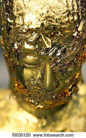 Stock Image - Thailand, Bangkok, Grand Palace and emerald Buddha temple "Wat Phra Keo", Buddha statue gilted with gold leaves offered by believers. Fotosearch