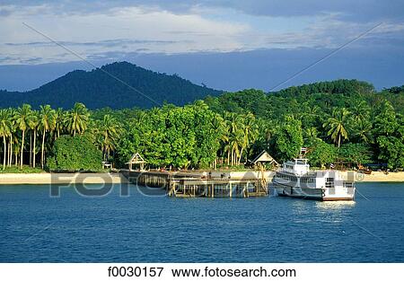 Thailand, Koh Lanta Yai island, beach and coconut palmes plantations, pier and boat View Large Photo Image Stock Photo - Thailand, Koh Lanta Yai island, beach and coconut palmes plantations, pier and boat. Fotosearch