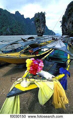 Thailand, Phang Nga bay, long tail boats and the nail island or "James Bond island" in the background View Large Photo Image Stock Image - Thailand, Phang Nga bay, long tail boats and the nail island or "James Bond island" in the background. Fotosearch