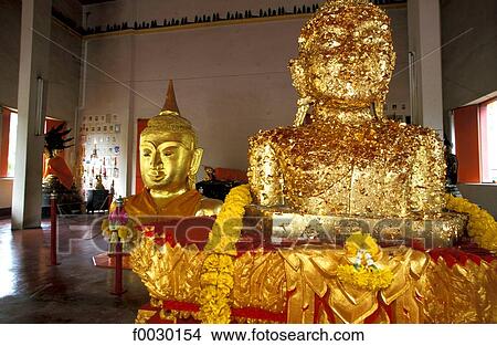 Thailand, Phuket island, gilted with gold leaves Buddha statues in a temple View Large Photo Image Picture - Thailand, Phuket island, gilted with gold leaves Buddha statues in a temple. Fotosearch