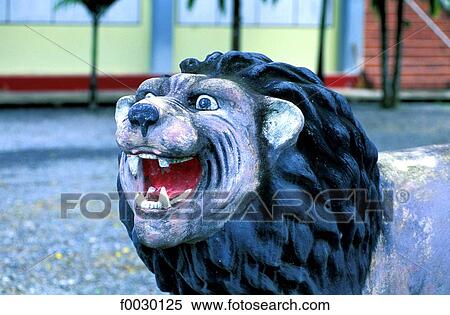 Thailand, Phuket island, naive lion sculpture in a temple yard View Large Photo Image Stock Photography - Thailand, Phuket island, naive lion sculpture in a temple yard. Fotosearch