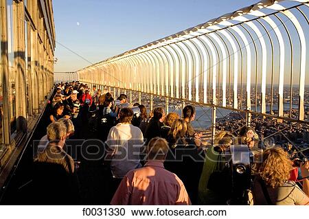 Stock Image - United States, New York, Manhattan, on top of the Empire State Building, tourists. Fotosearch