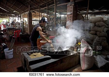 Stock Image - Vietnam, Can Tho, rice processing.. Fotosearch