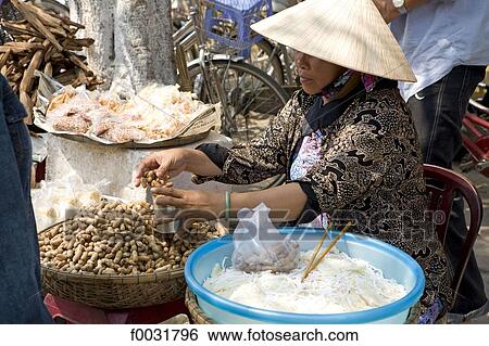 Vietnam, Hoi An, seller of peanuts. View Large Photo Image Stock Photograph - Vietnam, Hoi An, seller of peanuts.. Fotosearch