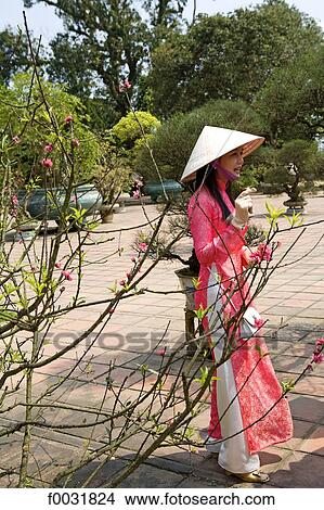 Vietnam, Hue, Imperial city, woman in traditional costume. View Large Photo Image Picture - Vietnam, Hue, Imperial city, woman in traditional costume.. Fotosearch