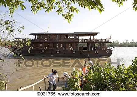 Vietnam, Mekong delta, tourists alighting from a boat. View Large Photo Image Stock Photography - Vietnam, Mekong delta, tourists alighting from a boat.. Fotosearch