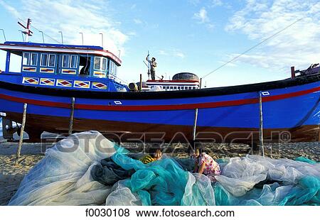 Vietnam, Nha Trang, fishing boat and young girls playing in the nets View Large Photo Image Stock Photo - Vietnam, Nha Trang, fishing boat and young girls playing in the nets. Fotosearch