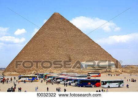 Stock Image - Egypt, Cairo, tourists in front of the pyramid of Kheops.. Fotosearch
