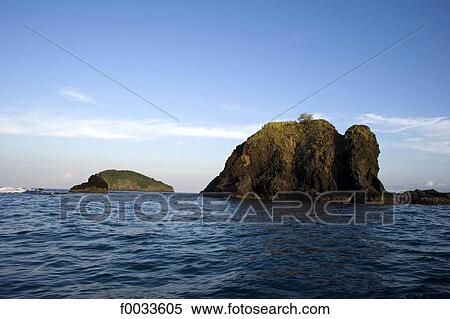 Stock Photography - Indonesia, Bali, Candidasa, rock opposite the town. Fotosearch