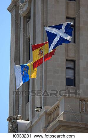 Stock Image - Spain, Canary islands, Tenerife, Santa Cruz, Torre del Cabildo, flags. Fotosearch