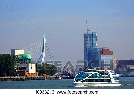 Stock Image - The Netherlands, South Holland, Rotterdam, boat and Erasmus bridge in the background. Fotosearch