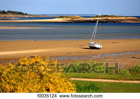 Picture - France, Brittany, La Trinite sur Mer, boat on the beach. Fotosearch