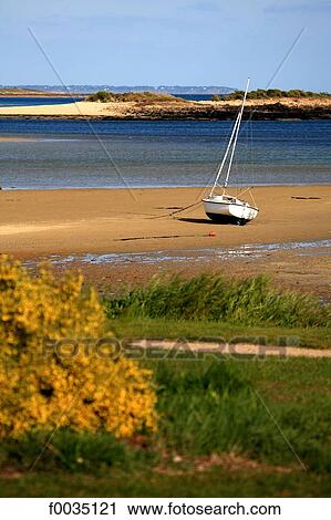 Stock Image - France, Brittany, La Trinite sur Mer, boat on the beach. Fotosearch