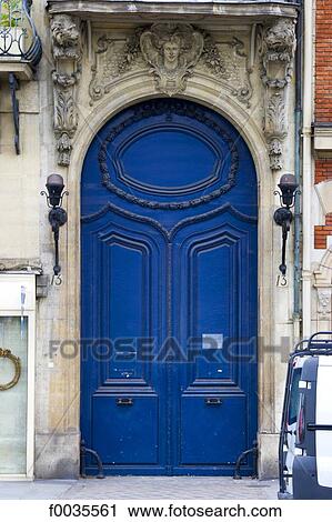Stock Image - France, Paris (75), Ile de France, blue door and sculptures. Fotosearch