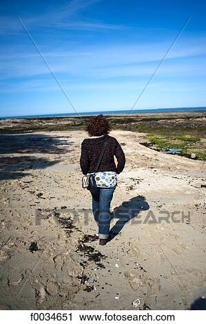 Stock Image - France, Pays de la Loire, Piriac-sur-Mer, walking on the beach. Fotosearch