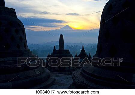 Stock Photo - Indonesia, Java, Borobudur temple and mount Merapi in the background. Fotosearch