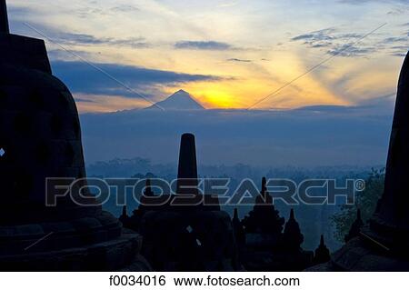 Indonesia, Java, Borobudur temple and mount Merapi in the background View Large Photo Image Stock Photograph - Indonesia, Java, Borobudur temple and mount Merapi in the background. Fotosearch