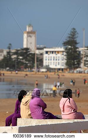 Morocco, Essaouira, veiled woment on the embankment and the medina in the background View Large Photo Image Stock Photo - Morocco, Essaouira, veiled woment on the embankment and the medina in the background. Fotosearch