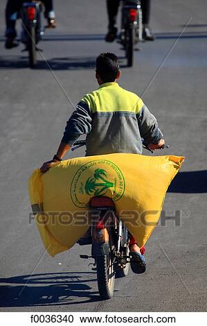Stock Image - Morocco, Marrakech, carrying grains. Fotosearch