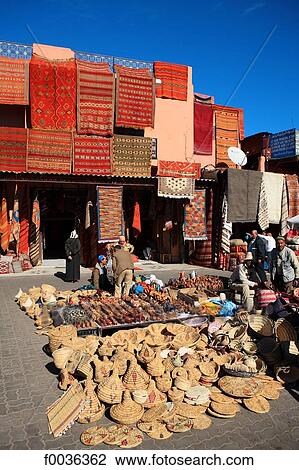 Stock Image - Morocco, Marrakech, souk, seller of carpets and souvenirs. Fotosearch