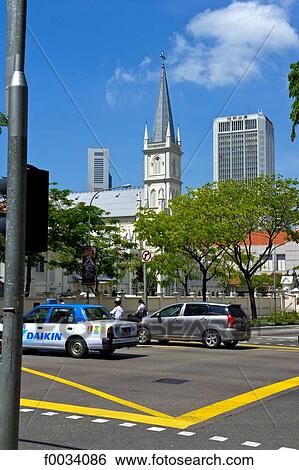 Stock Photograph - Singapore, street and ancient church change into a restaurant in the background. Fotosearch