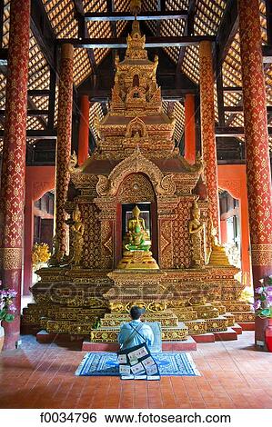 Thailand, Chiang Mai, Wat Phra Singh temple, man praying in front of a jade Buddha View Large Photo Image Stock Photograph - Thailand, Chiang Mai, Wat Phra Singh temple, man praying in front of a jade Buddha. Fotosearch