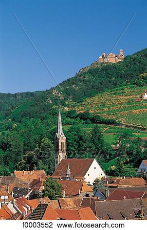 Stock Image - France, Alsace, Village of Ribeauvillé and Château St Ulrich in back. Fotosearch