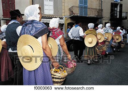Stock Image - France, Valensole, men and women wearing the traditional Provencal costume. Fotosearch