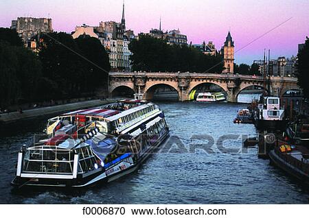 Stock Image - France, Paris, Riverbus passing by the Pont-Neuf Bridge. Fotosearch