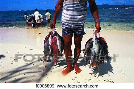 Stock Photo - Seychelles, La Digue Island, fisherman. Fotosearch