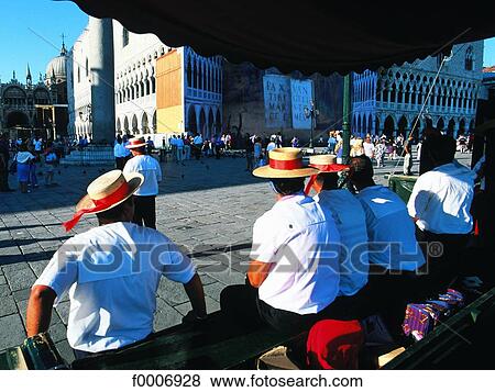 Stock Photo - Italy, Venice, Gondoliers sitting on Saint Mark's Square. Fotosearch