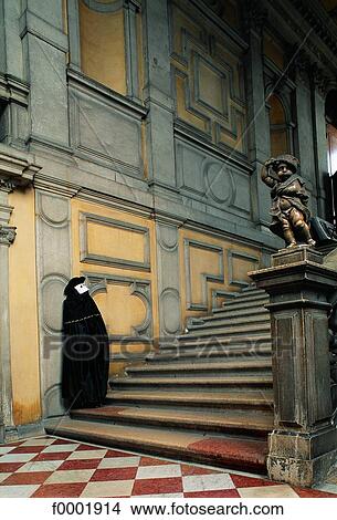 Italy, Venice, Masked man in front of Rezzonico Palace stairway View Large Photo Image Picture - Italy, Venice, Masked man in front of Rezzonico Palace stairway. Fotosearch