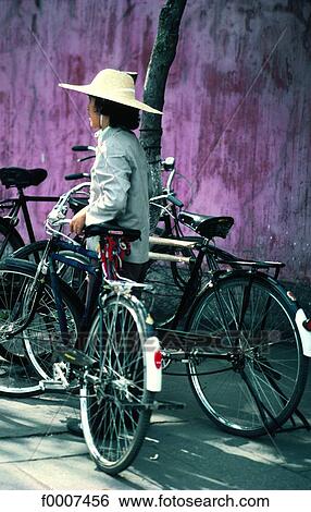 Stock Photograph - China, Canton, person on bicycle. Fotosearch