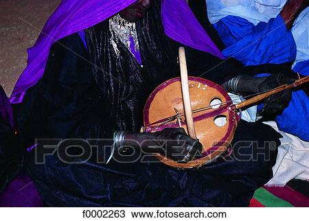 Stock Image - Algeria, Sahara, Tuareg musician. Fotosearch