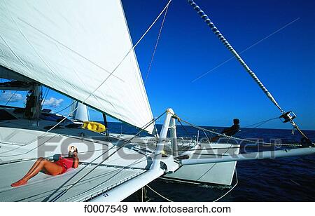 Virgin Islands, woman sunbathing on cruising catamaran View Large Photo Image Stock Photo - Virgin Islands, woman sunbathing on cruising catamaran. Fotosearch