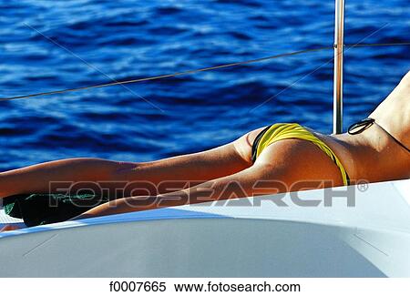 Virgin Islands, woman sunbathing on catamaran View Large Photo Image Stock Photography - Virgin Islands, woman sunbathing on catamaran. Fotosearch