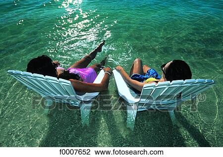 Virgin Islands, women sunbathing with their feet in the water View Large Photo Image Stock Image - Virgin Islands, women sunbathing with their feet in the water. Fotosearch