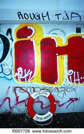 Stock Photo - Sweden, Stockholm, Buoy and graffiti on wall. Fotosearch