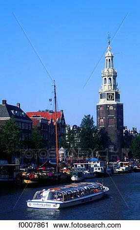 Stock Image - The Netherlands, Amsterdam, barges and tower. Fotosearch