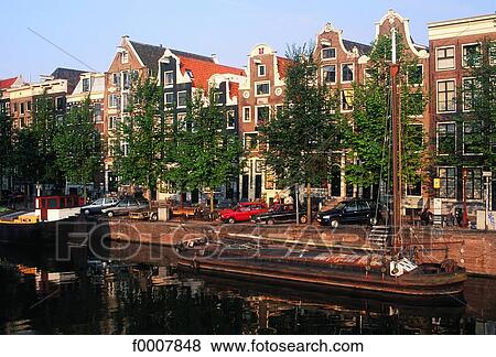 Stock Photo - The Netherlands, Amsterdam, houses by canal. Fotosearch