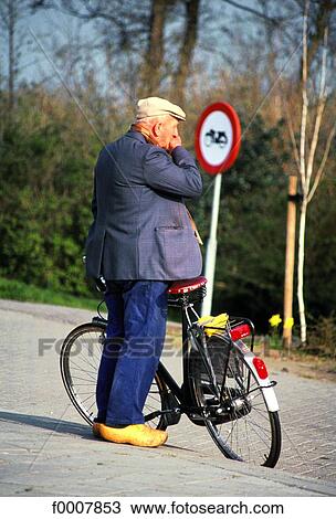 Stock Image - The Netherlands, Friesland, farmer and his bike. Fotosearch
