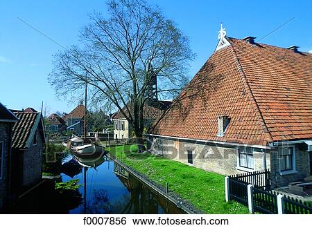 Stock Photograph - The Netherlands, Friesland, Hindeloopen, houses near canal. Fotosearch