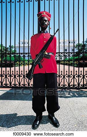 Stock Image - Senegal, Dakar, a soldier guarding the President's Palace. Fotosearch