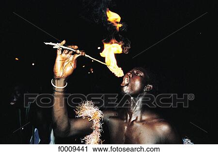Stock Image - Senegal, Saly, fire-eater. Fotosearch